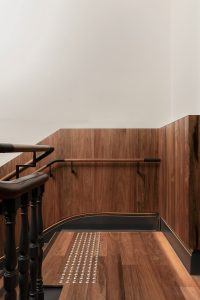 Warm timber staircase with dark wooden handrail and details — heritage restoration — Ballarat — Moloney Architects