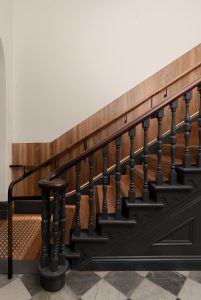 Warm timber staircase with checkerboard flooring and dark wooden handrail and details — heritage restoration — Ballarat — Moloney Architects