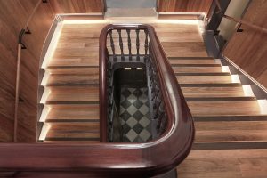 Warm timber staircase with built-in lighting, and dark wooden handrail and details — heritage restoration — Ballarat — Moloney Architects